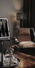 a living room with a chair and a picture on the wall