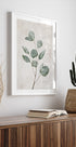 a picture of a plant and a book on a shelf