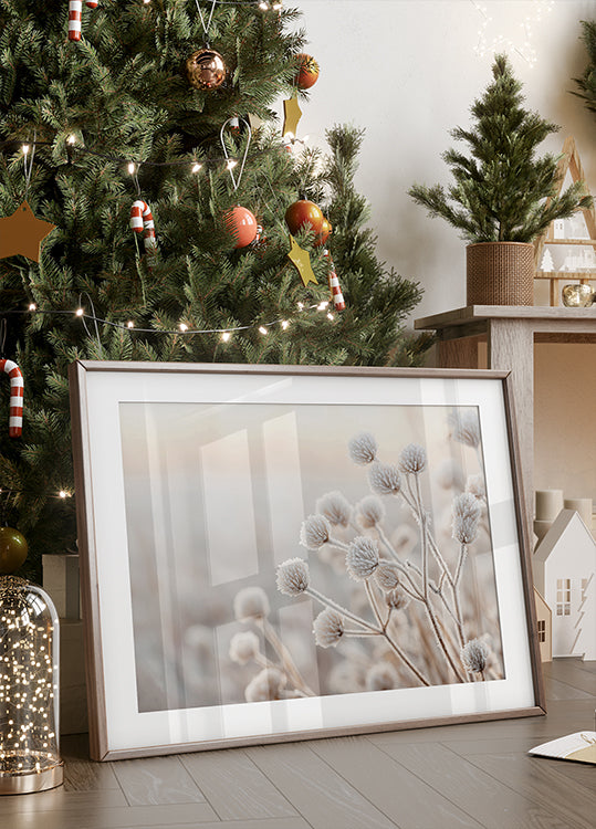 a picture frame sitting on a table next to a christmas tree