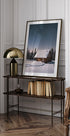 a room with a chair and a picture on a table