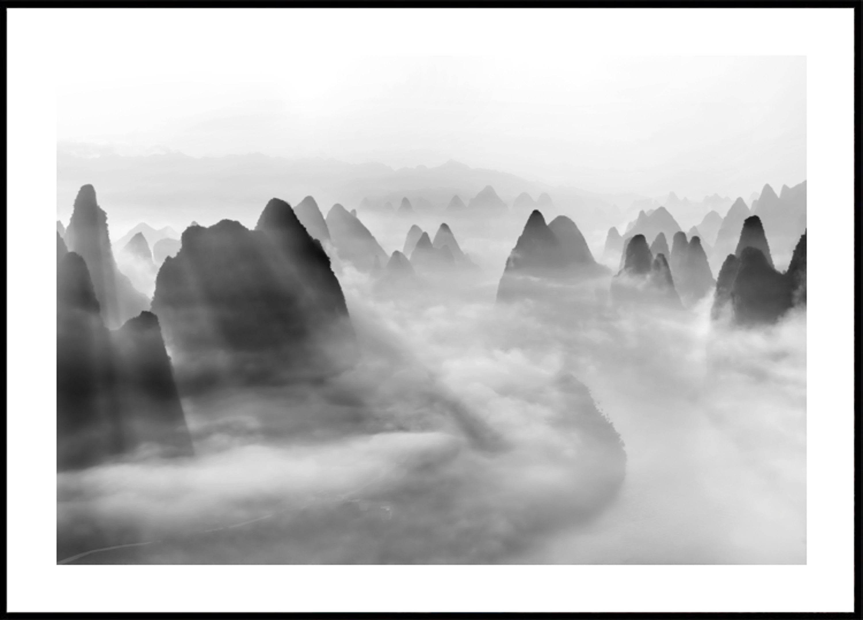 Light Rays Over Misty Peaks